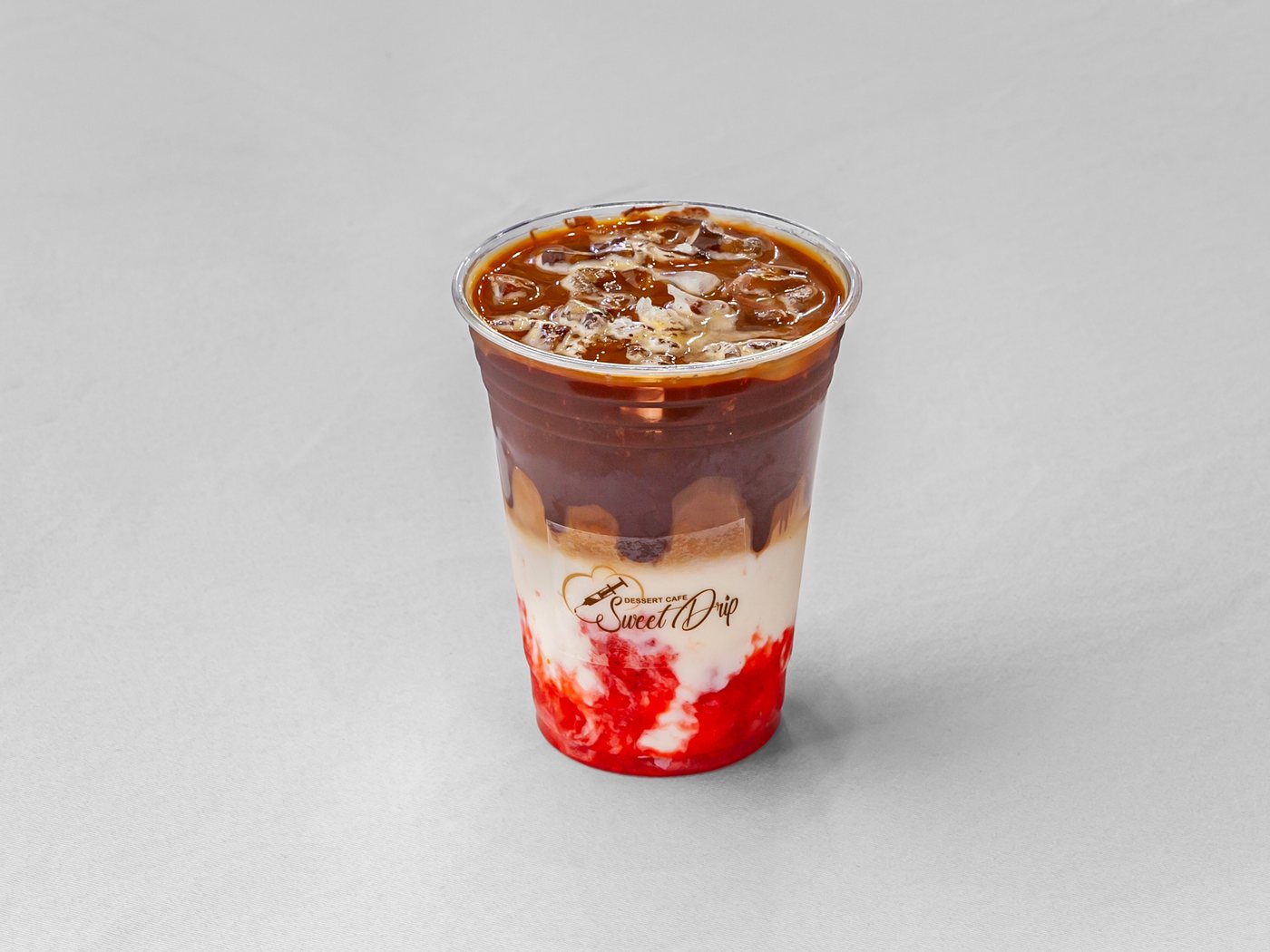 An iced latte in a Sweet Drip cup