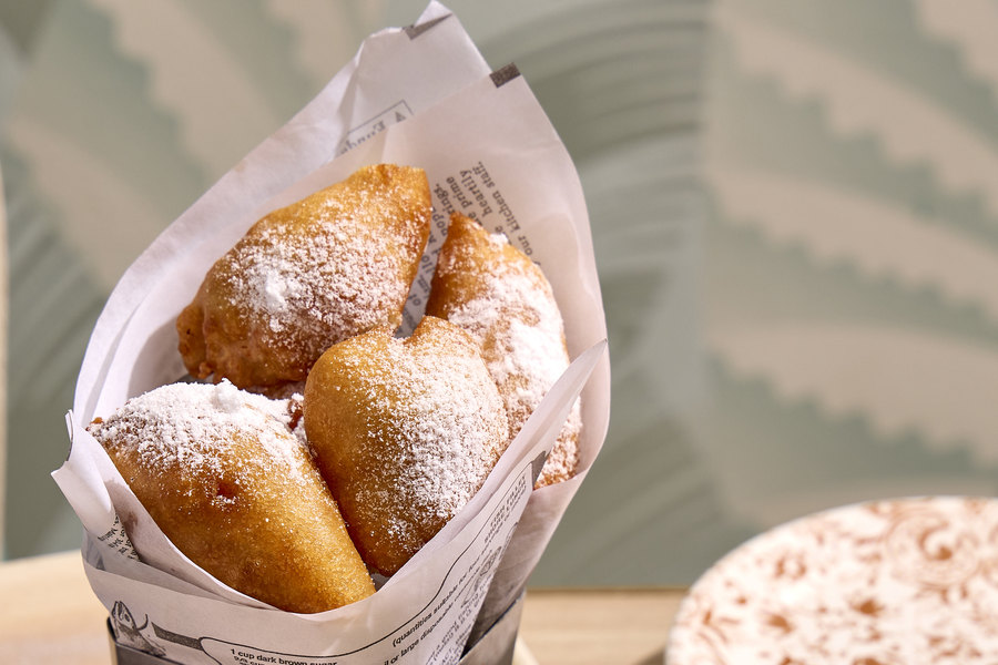 Dawn's Chicken & Waffle Bites dusted with powdered sugar in a paper-lined cone