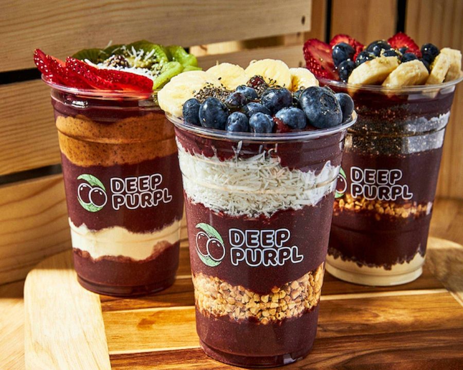 Three Deep Purpl açaí cups layered with granola, blueberries and banana